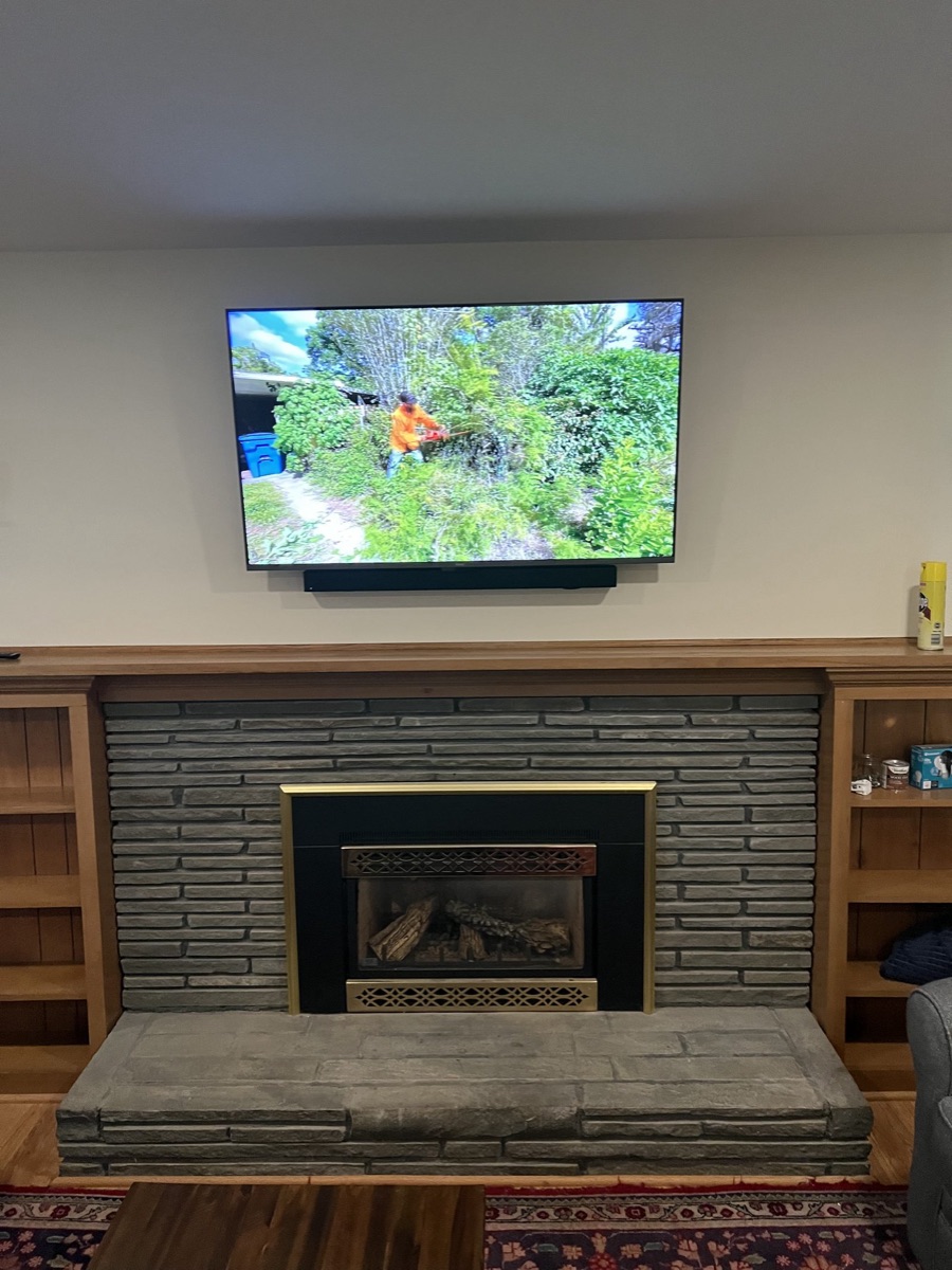 Clean TV and sound install over a stone fireplace